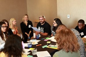 Picture of Raikes staff talking with partners.  credit: Raikes Foundation